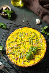 Сlassic quiche Lorraine pie with tuna, green beans and soft cheese. Crustless quiche with eggs, fish and vegetables. Mediterranean ketogenic healthy diet. Copy space.