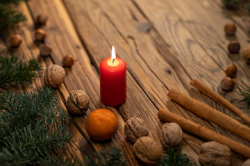 Traditional Czech Christmas on wood decoration with twig, candle, apple, orange, fruit