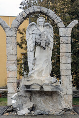 Angel in the arch with book and broken cross in Chortkiv town Ukraine