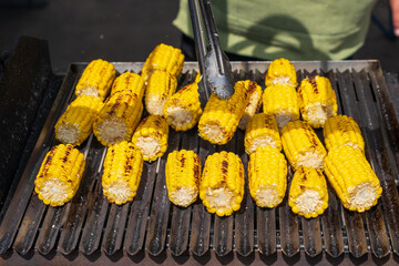 Close up of grilled corn for sale at the international street food festival, selective focus....