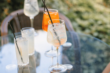 Alcoholic cocktails on cafe terrace on summer day. Copy space.