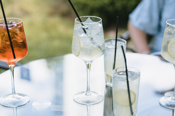 Refreshing drinks on table on cafe terrace. Summertime. Copy space.