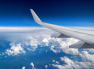 Airplane flying above clouds - traveling - sky