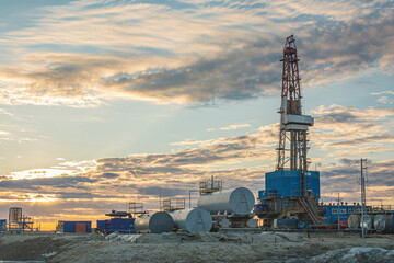 Infrastructure and equipment for drilling wells and oil and gas production. In the background there...