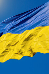 Flag of Ukraine on a background of blue sky. The largest flag in Ukraine.