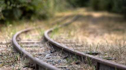 Disused narrow gauge railway tracks curving in to the distance