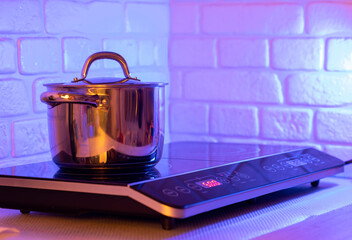 Metal Pot on induction hob in modern kitchen