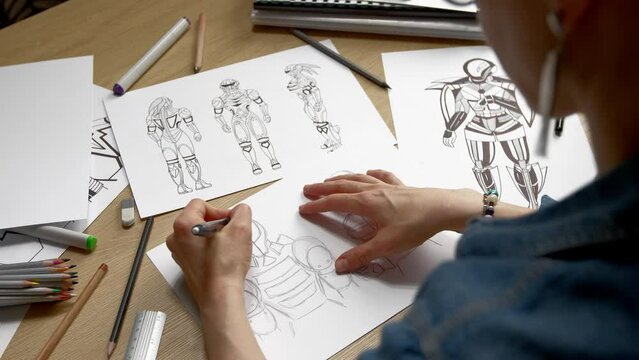 A woman artist draws on paper sketches of a storyboard of robots, cyborgs.