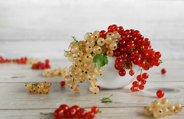 White and red currants.  Fresh fruits on the wooden background, copy space