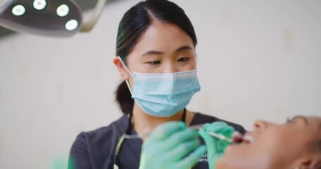 Dentist using excavator and mouth mirror tools to examine or check dental hygiene routine, fillings and gum disease in patient. Professional orthodontist or nurse using equipment in hygientist clinic