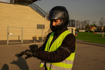 Заголовок	
Motorcyclist in a driving lesson. Lessons in auto and motorcycle school. A student in a special uniform drives a motorcycle. Summer training on a moped. Student and teacher.	
