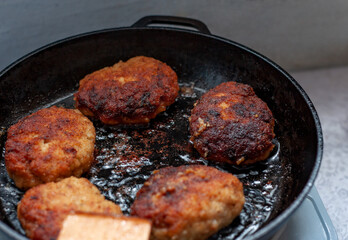 Cutlets are fried in a frying pan. Boiling oil. Cooking concept. Fast food. Lunch in the kitchen