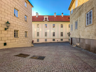 Prague Castle in the spring morning sun. Narrow streets, stairs and wonderful palaces in Prague Castle. A unique sight without a crowd of tourists on a wonderful spring morning. Prague Castle has been
