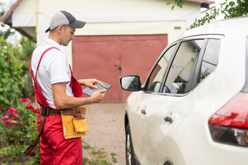 Close-up Of A Car Mechanic Using Digital Tablet