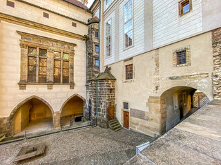 Fototapeta na wymiar Prague Castle in the spring morning sun. Narrow streets, stairs and wonderful palaces in Prague Castle. A unique sight without a crowd of tourists on a wonderful spring morning. Prague Castle has been
