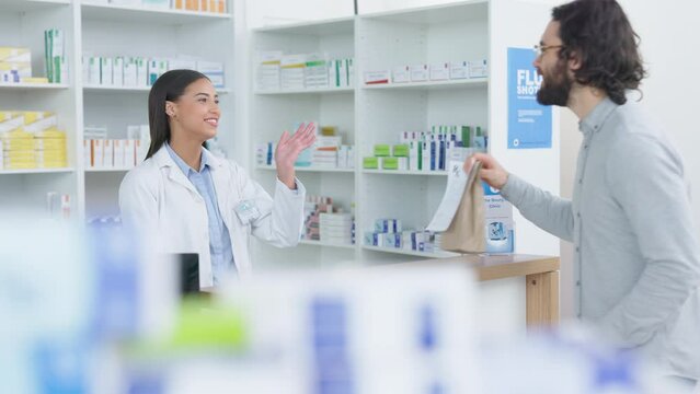 Patient buying medicine from pharmacist at the pharmacy store. Customer receives prescription medication at the chemist store from medical doctor. Healthcare professional accepts credit card payment
