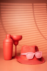 Cocktail glass, hat and shaker on a pink background. - Summer concept