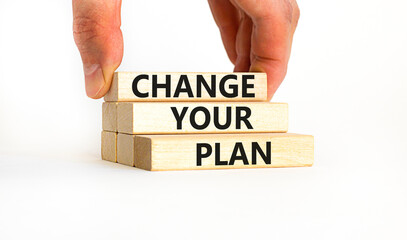 Change your plan symbol. Concept words Change your plan on wooden blocks on a beautiful white table white background. Businessman hand. Business, finacial and change your plan concept. Copy space.
