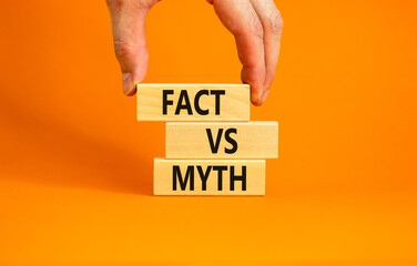 Fact vs myth symbol. Concept words Fact vs myth on wooden blocks on a beautiful orange table orange...