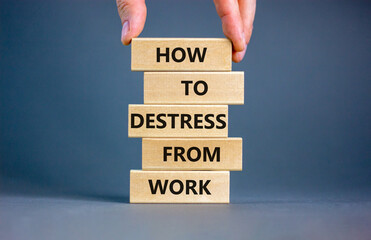 Destress from work symbol. Concept words How to destress from work on wooden blocks. Doctor hand. Beautiful grey background. Psychological business and destress from work concept. Copy space.