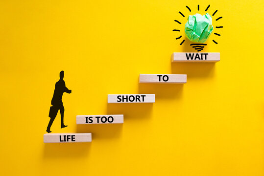 Life is short to wait symbol. Concept words Life is too short to wait on wooden blocks on a beautiful yellow table yellow background. Businessman icon. Business motivational life or wait concept.