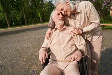 Fototapeta premium Pleased aged female person caressing her man