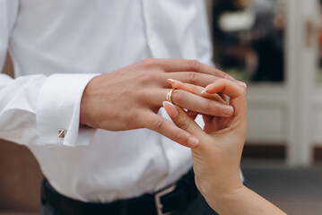 Obraz premium wedding rings on hands