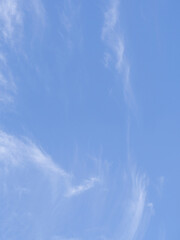 Blue sky and white fluffy clouds, natural background. Cloudy background with white soft clouds on a blue sky background