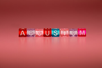 the word "accustom" made up of cubes