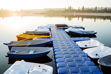 Boat station boats moored to the pier on the river, rental of swimming facilities, floating pier,...