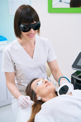 Female patient in cosmetology center undergoes neck skin rejuvenation procedure