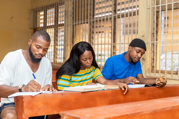 group of African black university student taking notes during lecture in the classroom.