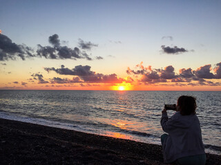 Sunset, sea and beach. red sky, Photographer