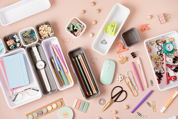 Desktop organization. Cleaning up messy stationary in plastic organizers for office and home desk