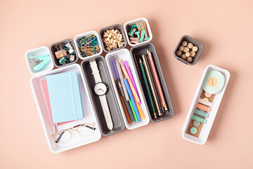 Desktop organization. Cleaning up messy stationary in plastic organizers for office and home desk
