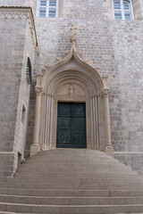 The weathered green door marks the entrance to the Dominican Monastery