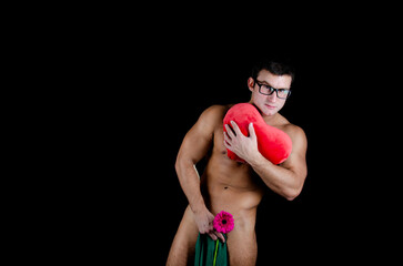 Holidays and gifts. Young handsome man with athletic body posing in the studio. 