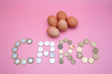 Some eggs with the word dear written with coins 