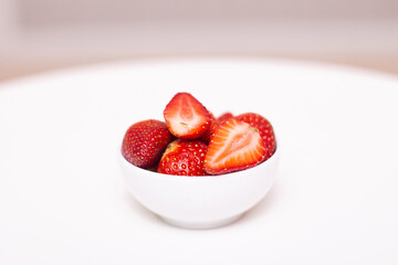 Sweet strawberries on plate on white background