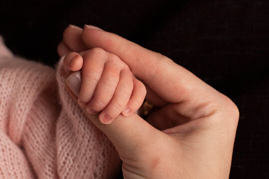 Portrait of cute bab, hand of mom and baby
