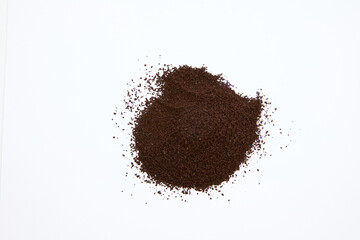 overhead shot of pile of coffee grounds isolated on white background 