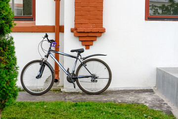 Fototapeta na wymiar Came to work on a bike. Strapped bike near work. Eco friendly trip, eco lifestyle