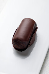 chocolate cake kartoshka on a white plate macro close up vertical