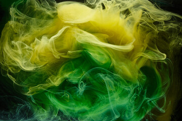 Fototapeta na wymiar Liquid fluid art abstract background. Green, yellow dancing acrylic paints underwater, space smoke ocean, color explosion