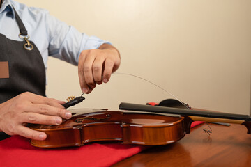 Artisan repairing a violin in a workshop