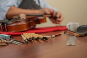 Workshop with a raw of different tools to repair a violin