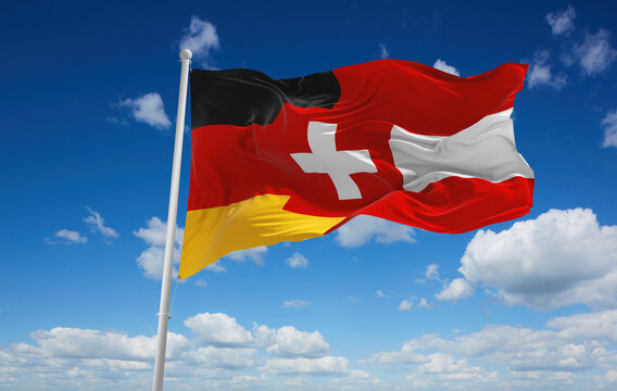 official flag of Austria, Germany, Switzerland Austria at cloudy sky background on sunset, panoramic view. Austrian travel and patriot concept. copy space for wide banner