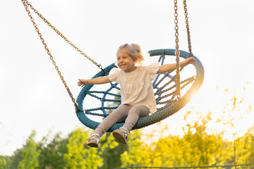 happy little girl on a big swing