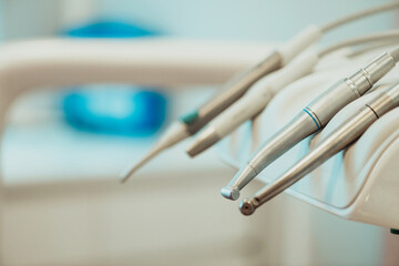 Closeup different dental instruments and tools, blue toning.