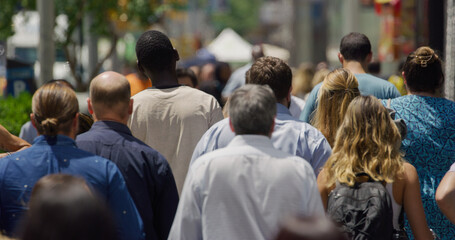 Crowd of people walking city street